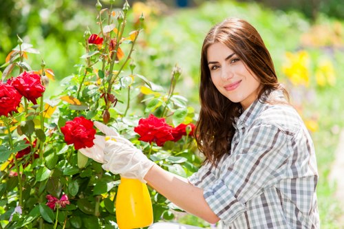 Worker using landscaping equipment with proper safety measures